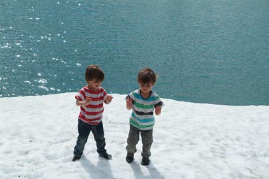 Boys on snow, turquoise lake, Styrn, Norway.